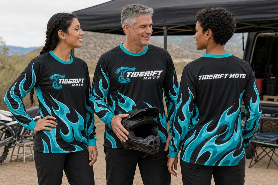 TIDERIFT MOTO team wearing Aqua Afterburn shirts. Helmet handoff moment.
